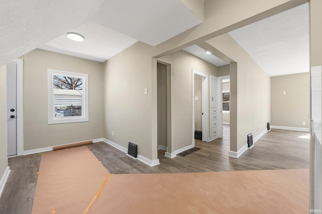 4121 Smith St, Fort Wayne, IN 46806 - additional living space with a textured ceiling, wood finished floors, and baseboards