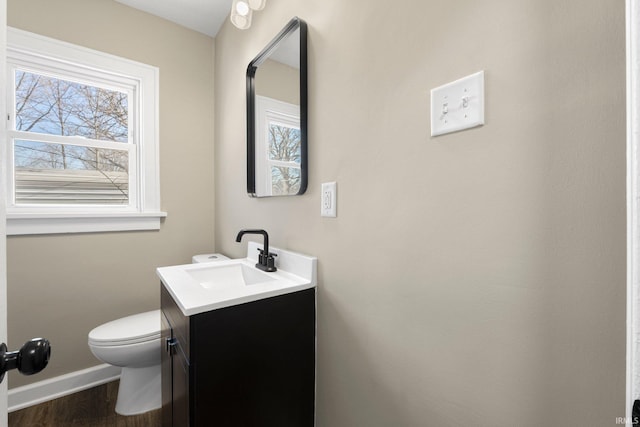 4121 Smith St, Fort Wayne, IN 46806 - half bath featuring vanity, baseboards, wood finished floors, and plenty of natural light