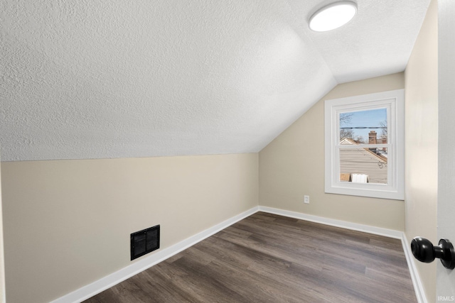 4121 Smith St, Fort Wayne, IN 46806 - bonus room with a textured ceiling, visible vents, vaulted ceiling, and baseboards