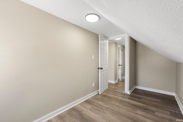 4121 Smith St, Fort Wayne, IN 46806 - additional living space with a textured ceiling, wood finished floors, and baseboards