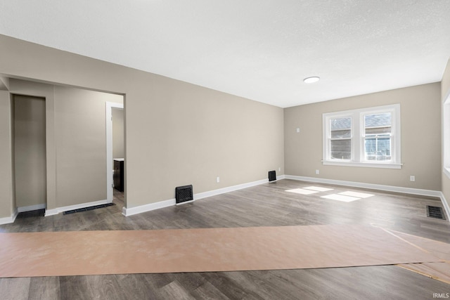 4121 Smith St, Fort Wayne, IN 46806 - unfurnished living room featuring visible vents, wood finished floors, and baseboards
