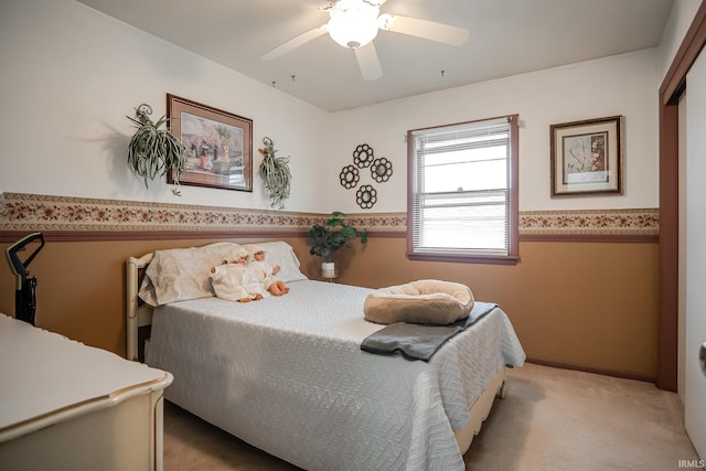 bedroom featuring ceiling fan and carpet