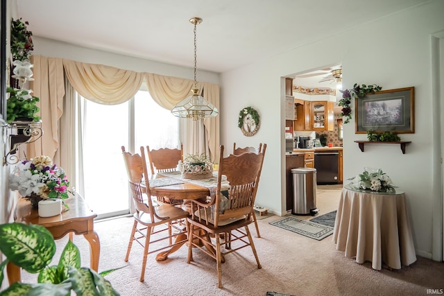 dining room featuring ceiling fan and light colored carpet