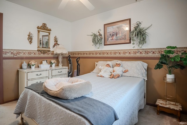 bedroom with a ceiling fan and light carpet