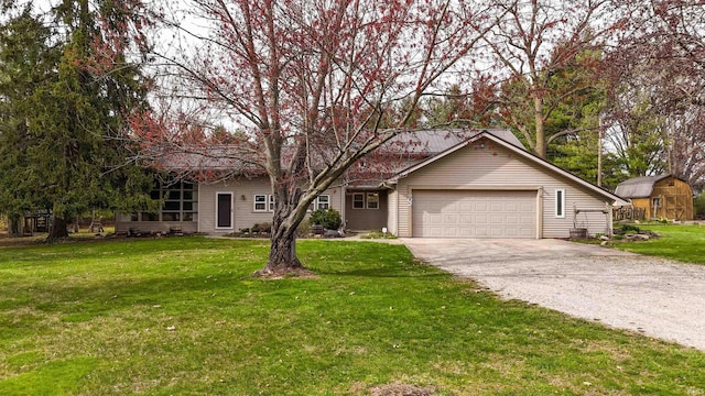 ranch-style home with a garage, a front yard, and driveway