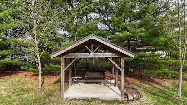 view of property's community featuring a lawn, a gazebo, and a patio area
