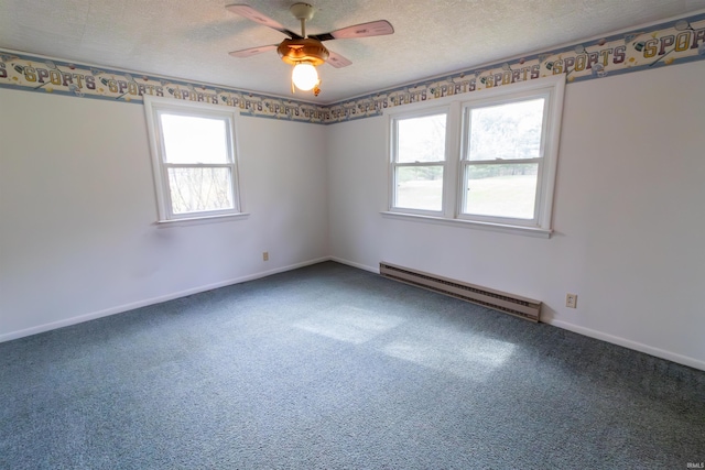 carpeted empty room with a baseboard heating unit, a textured ceiling, ceiling fan, and plenty of natural light