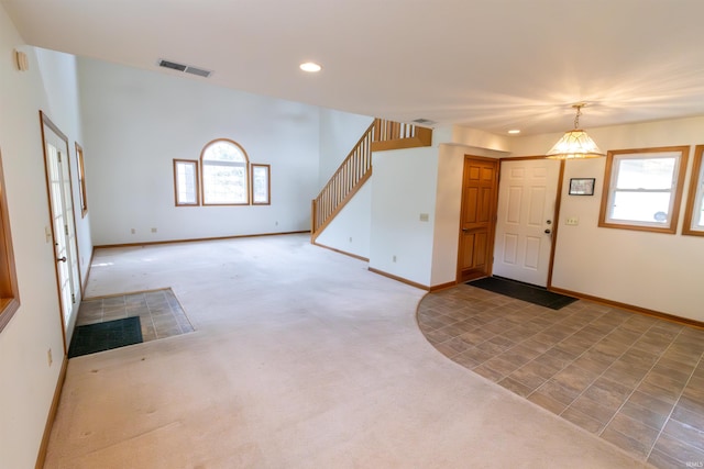 entryway with a wealth of natural light, visible vents, recessed lighting, and carpet
