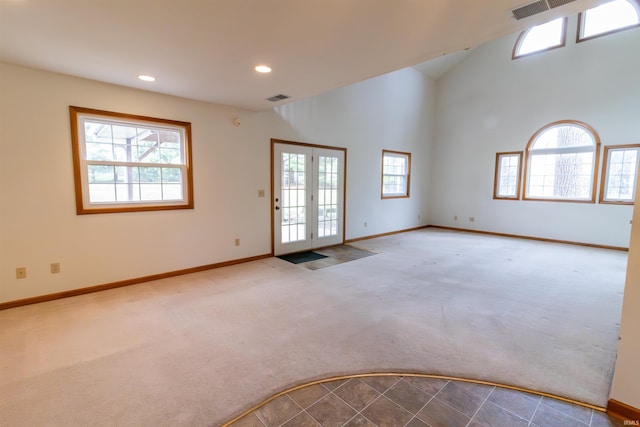 empty room featuring visible vents, baseboards, and carpet floors