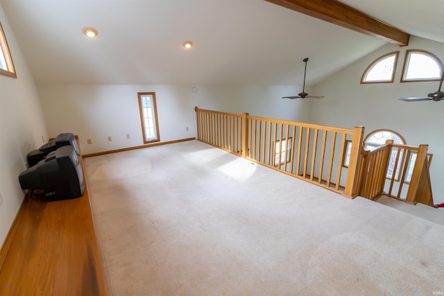 bonus room featuring beamed ceiling, a ceiling fan, carpet, baseboards, and plenty of natural light