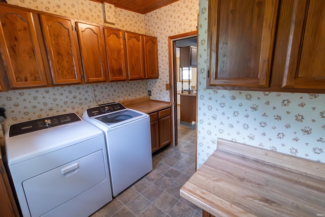 laundry area with washer and dryer, cabinet space, and wallpapered walls