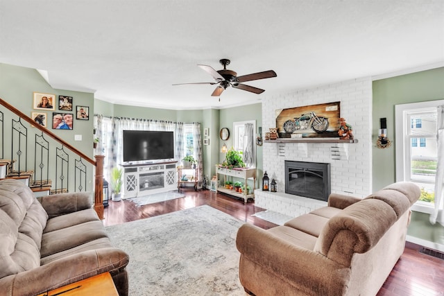 719 E Mitchell St, Kendallville, IN 46755 - living area with visible vents, wood finished floors, a ceiling fan, and a fireplace