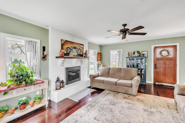 719 E Mitchell St, Kendallville, IN 46755 - living area with a brick fireplace, plenty of natural light, a ceiling fan, and dark wood-type flooring