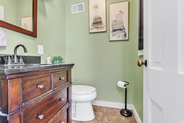 719 E Mitchell St, Kendallville, IN 46755 - bathroom featuring toilet, vanity, and baseboards