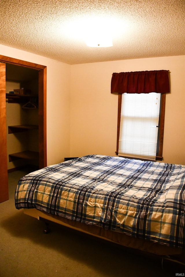 carpeted bedroom with a textured ceiling