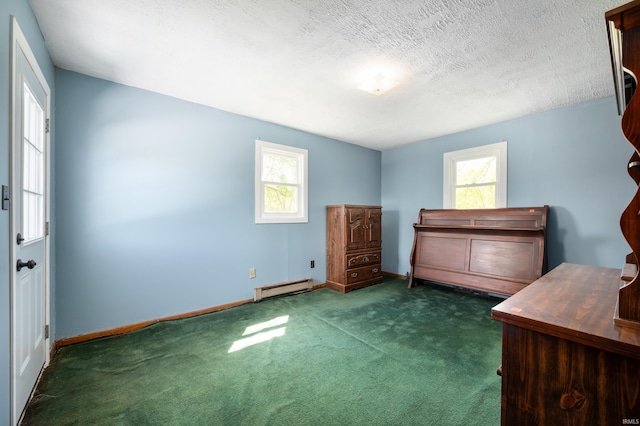 unfurnished bedroom with baseboard heating, baseboards, carpet floors, and a textured ceiling
