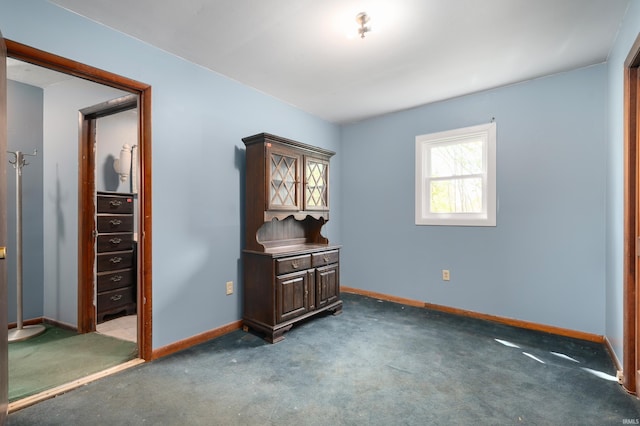 bedroom featuring carpet flooring and baseboards
