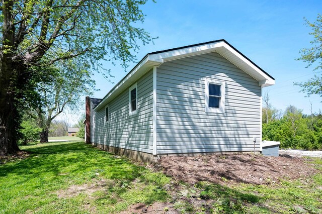 view of side of property with a lawn
