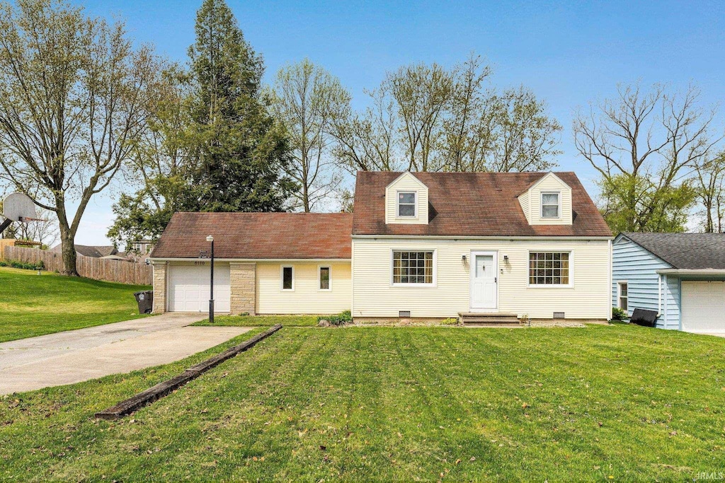 cape cod-style house with driveway, a front lawn, and an attached garage