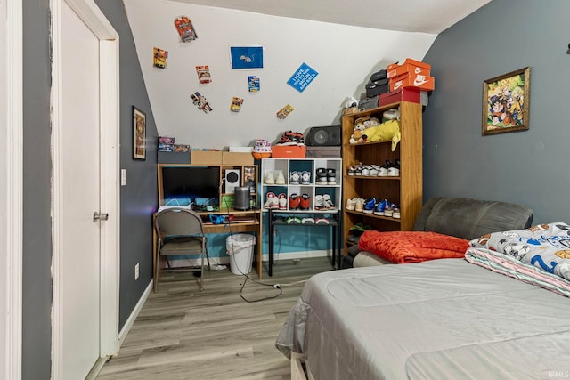 bedroom featuring baseboards and wood finished floors