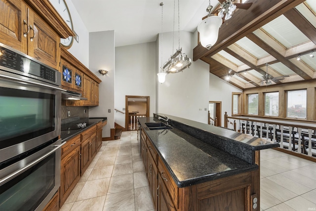 1711 Old Plank Rd, Newburgh, IN 47630 - kitchen with a ceiling fan, a center island with sink, stainless steel double oven, beamed ceiling, and light tile patterned flooring