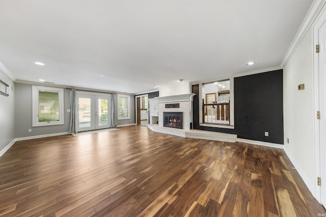 1711 Old Plank Rd, Newburgh, IN 47630 - unfurnished living room with crown molding, wood finished floors, baseboards, a brick fireplace, and recessed lighting