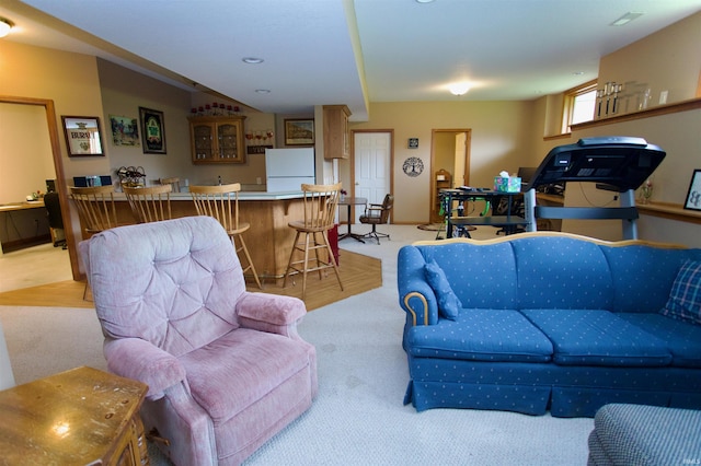 living room with wet bar and light colored carpet