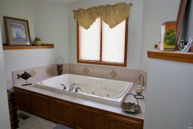 bathroom with visible vents and a jetted tub