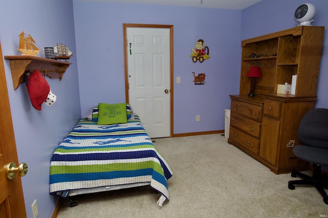 bedroom with baseboards and light carpet
