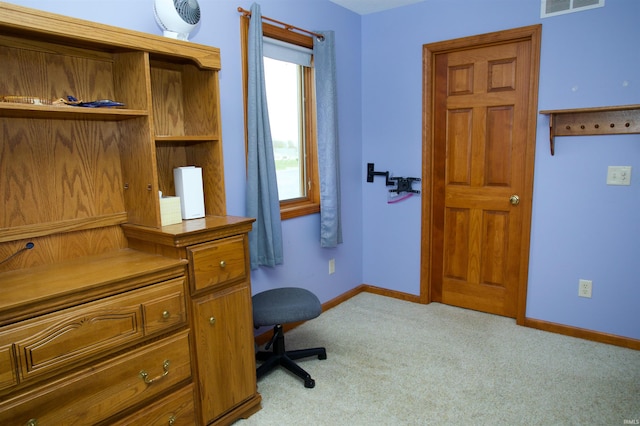 carpeted office featuring visible vents and baseboards