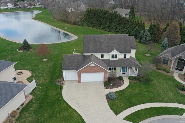 birds eye view of property with a water view