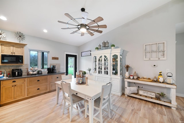 dining area featuring ceiling fan, recessed lighting, light wood-style flooring, and vaulted ceiling