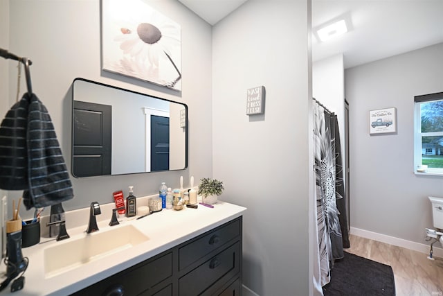 full bath with marble finish floor, vanity, and baseboards