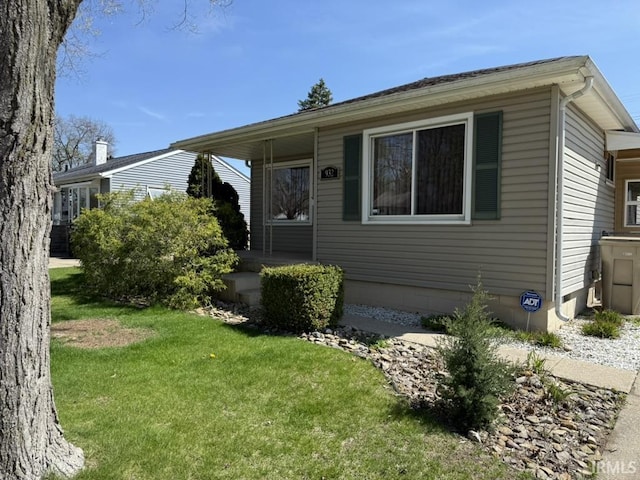 view of front of home with a porch and a front yard