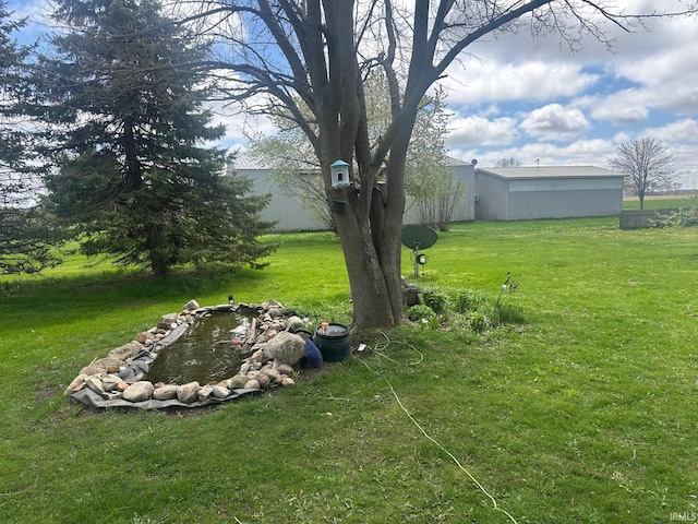view of yard with an outdoor structure and a pole building