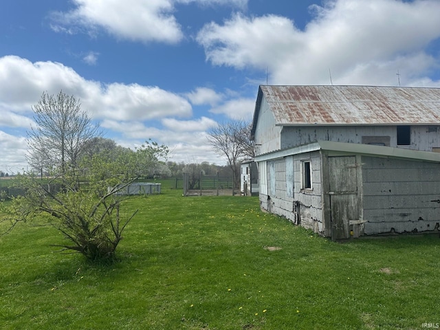 exterior space featuring a barn, an outbuilding, and a lawn