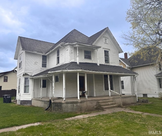victorian house featuring a porch and a front yard