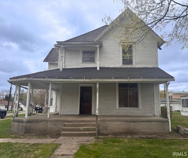 view of front facade featuring covered porch and roof with shingles