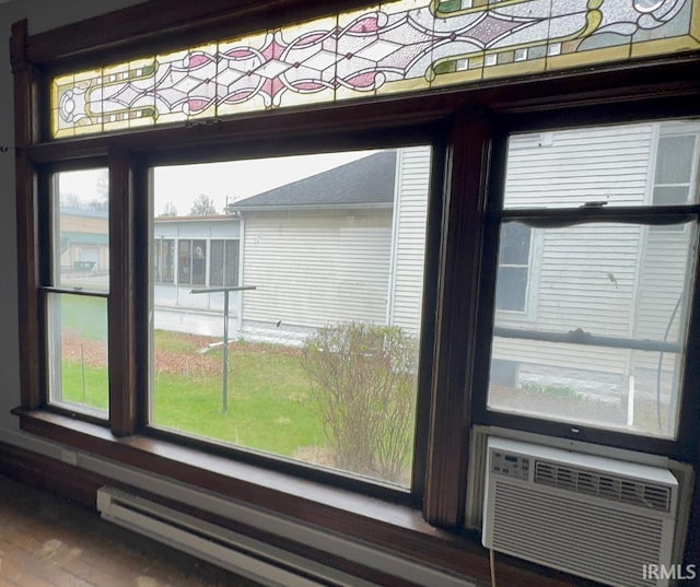 interior details with wood finished floors, cooling unit, and a baseboard heating unit
