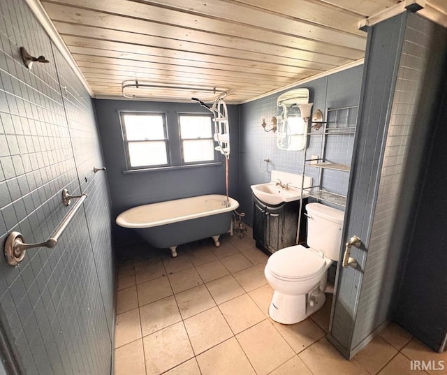 bathroom with toilet, a freestanding bath, tile patterned flooring, and wooden ceiling