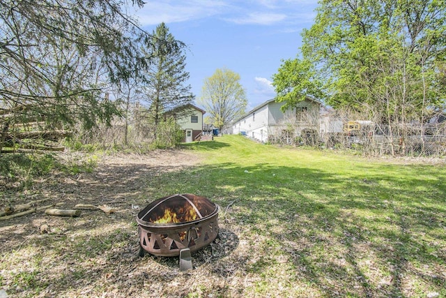 view of yard featuring fence and an outdoor fire pit
