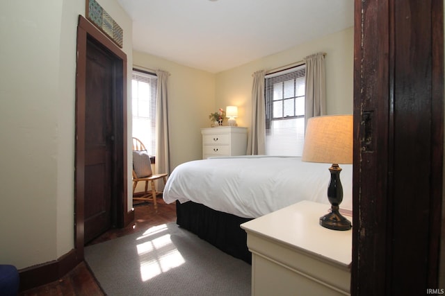 1509 W Glenn Ellyn Dr Unit 9Sfam, Homes Total, Muncie, IN 47304 - bedroom featuring multiple windows, wood finished floors, and baseboards