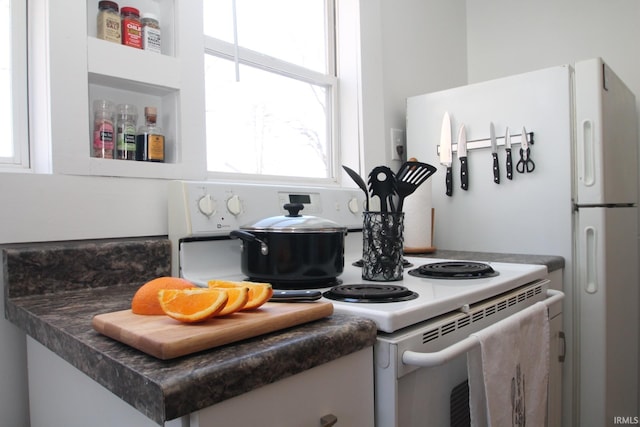 1509 W Glenn Ellyn Dr Unit 9Sfam, Homes Total, Muncie, IN 47304 - kitchen featuring dark countertops, white cabinetry, and electric range