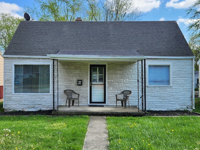 1509 W Glenn Ellyn Dr Unit 9Sfam, Homes Total, Muncie, IN 47304 - view of front facade with covered porch, a front yard, and stone siding