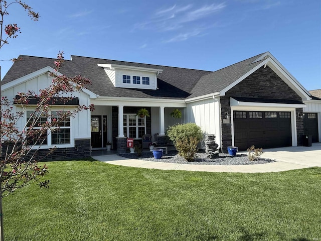 craftsman-style home with a porch, a front lawn, driveway, board and batten siding, and an attached garage