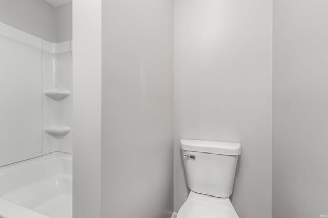 bathroom with walk in shower and toilet