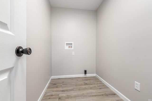 laundry room featuring baseboards, washer hookup, laundry area, and light wood-style floors