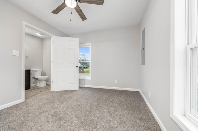 unfurnished bedroom with ensuite bath, carpet, electric panel, and baseboards