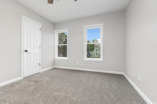 unfurnished bedroom with baseboards, a ceiling fan, and carpet floors