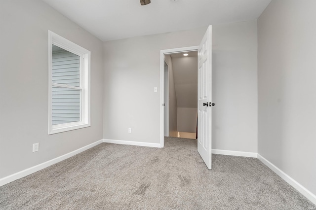 unfurnished bedroom with carpet flooring and baseboards